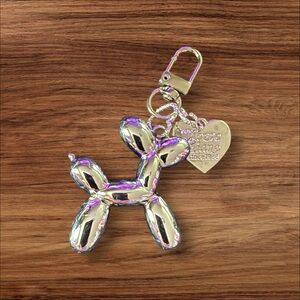 Bright Silver Balloon Dog Keychain with Heart Charm.